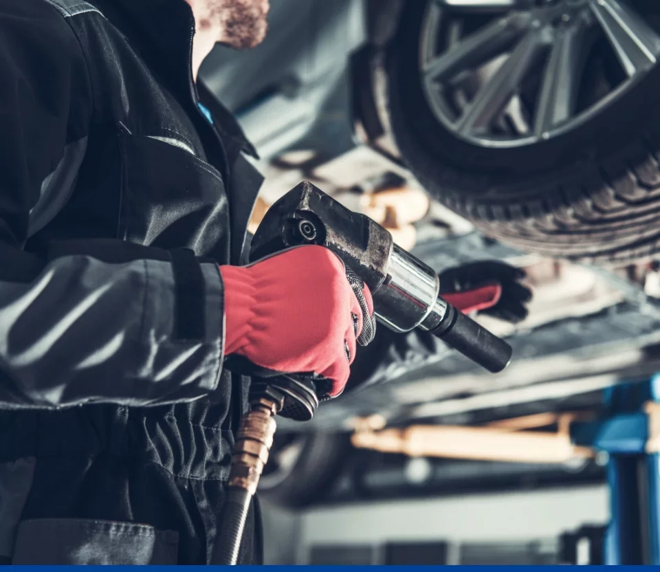 mężczyzna zaglądający pod&nbsp;samochód